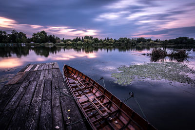 Scenic view of lake against sky at sunset