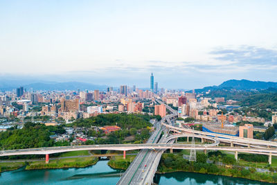 High angle view of bridge over river and buildings against sky