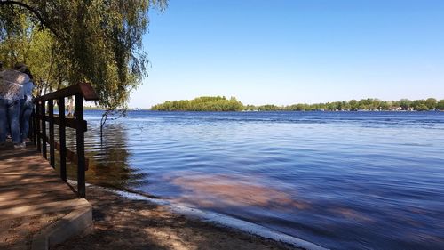 Pier over lake against clear sky