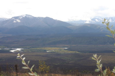 Scenic view of landscape and mountains against sky