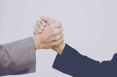 Close-up of hands over white background