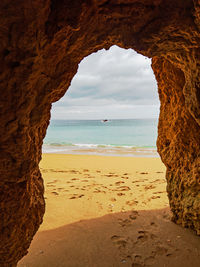 Scenic view of sea seen through cave