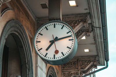 Low angle view of clock on illuminated building