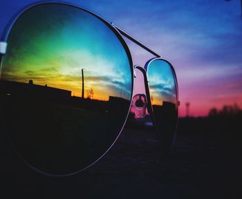 Close-up of sunglasses on side-view mirror