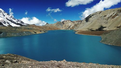 Panoramic view of lake and mountains against blue sky