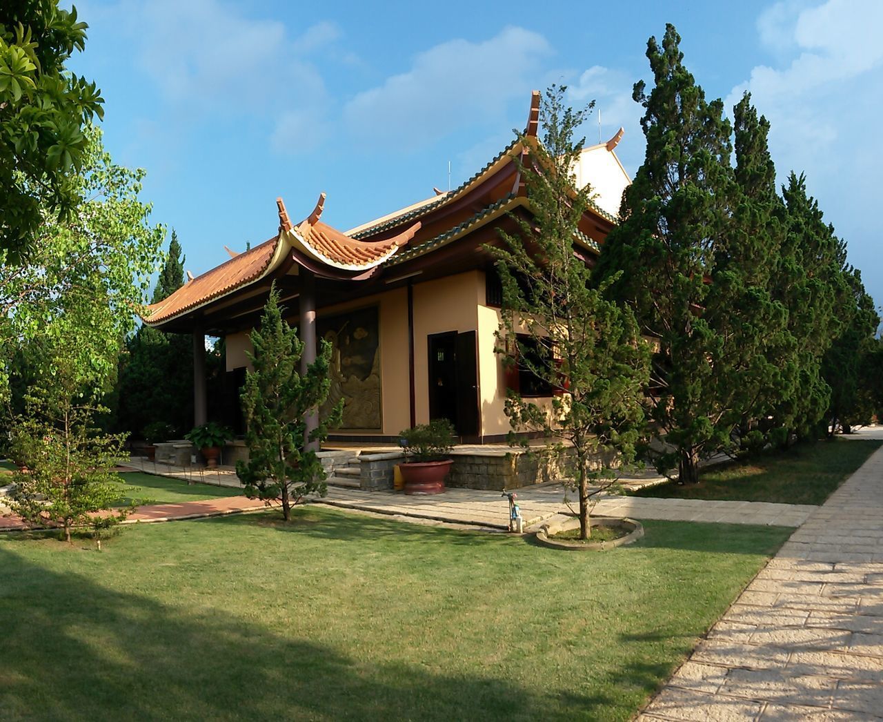 TEMPLE BY BUILDING AGAINST SKY