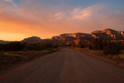 Road amidst landscape against sky during sunset