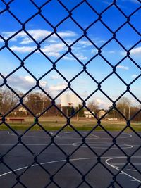 Chainlink fence seen through chainlink fence