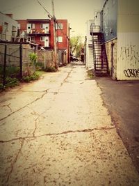 Empty alley amidst buildings in city