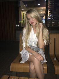 Young woman smiling while sitting on seat