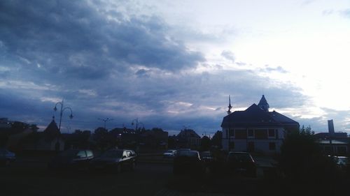 Buildings against cloudy sky