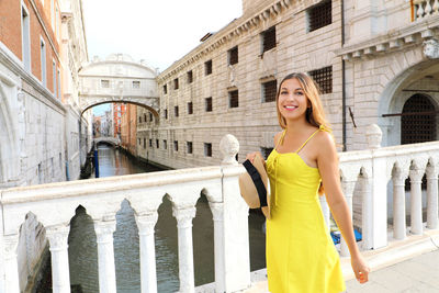 Young woman on venice bridge of sighs. beautiful girl looking to the side on venice bridge, italy.