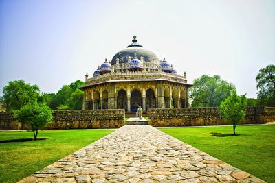 View of historical building in garden against clear sky