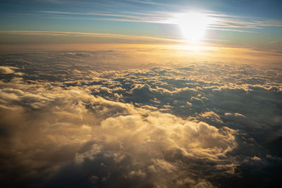 Sunset in the clouds as we descend over the mediterranean sea into catania 