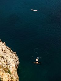 Aerial view of people swimming in sea