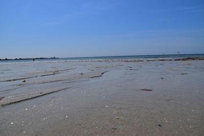 Scenic view of beach against clear blue sky