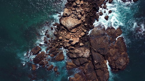 High angle view of rock formation in sea