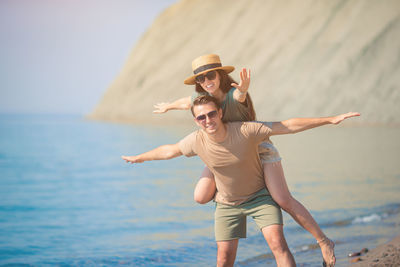 Full length of woman standing at beach