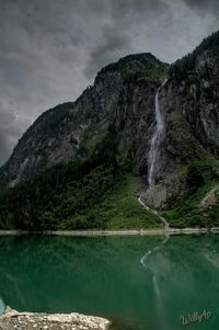 Scenic view of waterfall against sky