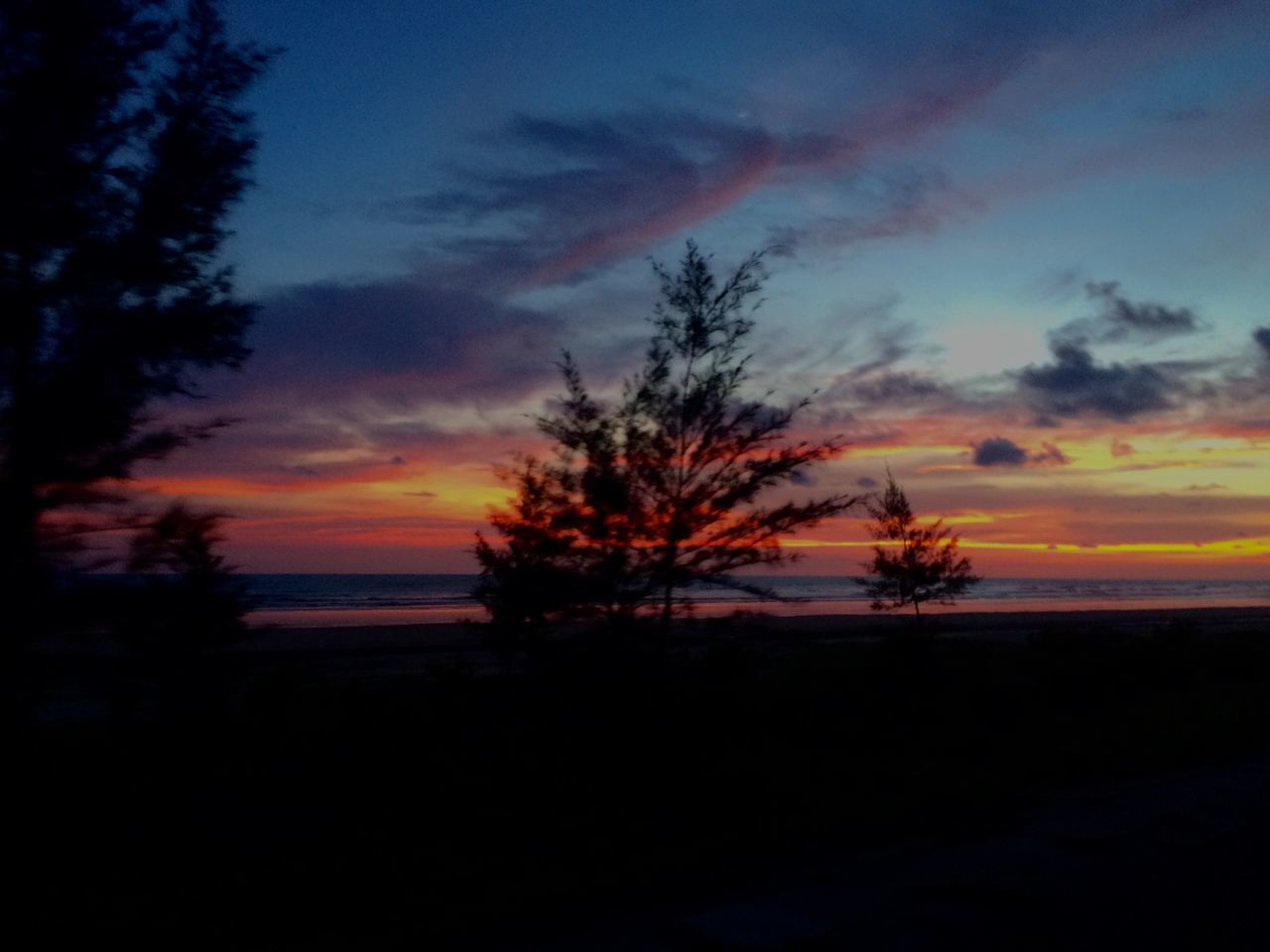 sunset, tranquil scene, scenics, tranquility, sky, beauty in nature, orange color, silhouette, sea, horizon over water, idyllic, water, nature, beach, cloud - sky, tree, dramatic sky, shore, cloud, outdoors