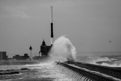 Waves splashing on dam in sea