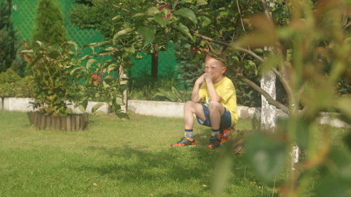 Portrait of young woman sitting on grass