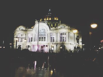 Illuminated building in city at night