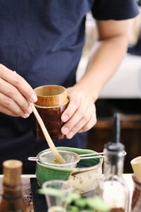 Midsection of man preparing food on table