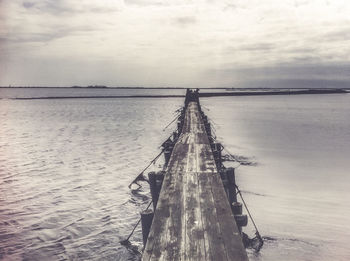 Pier over sea against sky