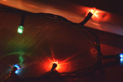 Close-up of illuminated lights against sky