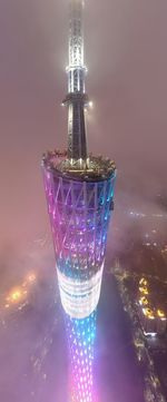 Close-up of illuminated tower against sky at night