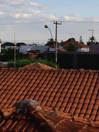 Houses by street against sky in city