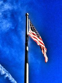 Low angle view of poles against blue sky