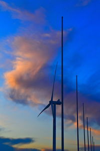 Low angle view of wind turbine against dramatic sky