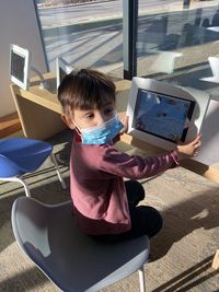 High angle view of  boy using tablet