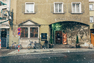 Bicycle on street against building in city