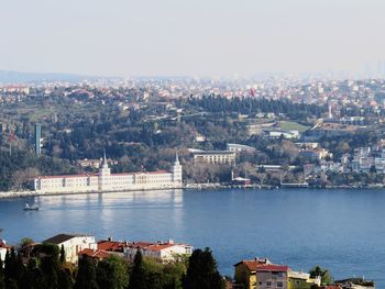 High angle view of river by buildings against sky