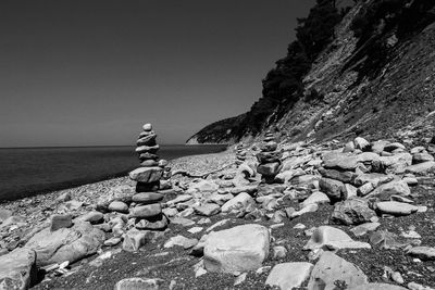 Rocks on beach against clear sky