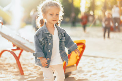 Cute girl looking away while walking at playground