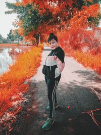 Full length of man standing by plants during autumn