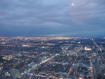 Aerial view of illuminated city buildings against sky at dusk