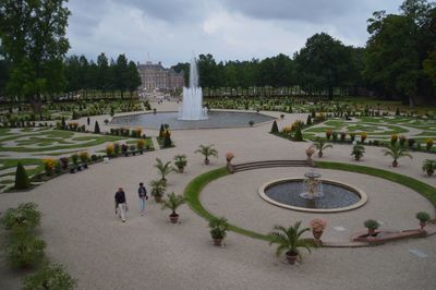 People in garden with building in background