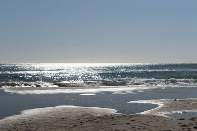Scenic view of beach against clear sky
