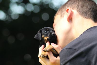 Portrait of man holding dog