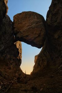 Low angle view of rock formation against sky
