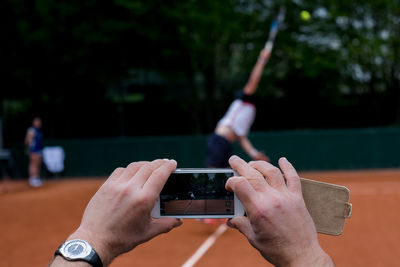 Close-up of hand holding mobile phone