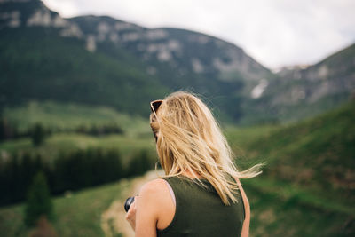 Rear view of woman against mountains