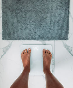 Low section of woman standing on floor