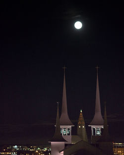 Illuminated city against sky at night