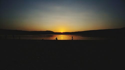 Scenic view of beach against sky during sunset